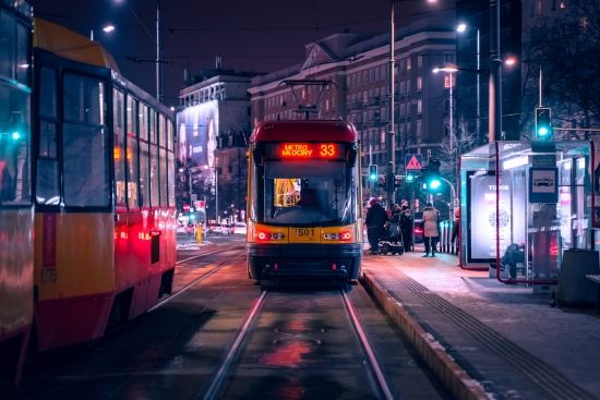 Tram on road during night time in Warsaw