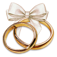 A pair of gold rings with a bow

Description automatically generated